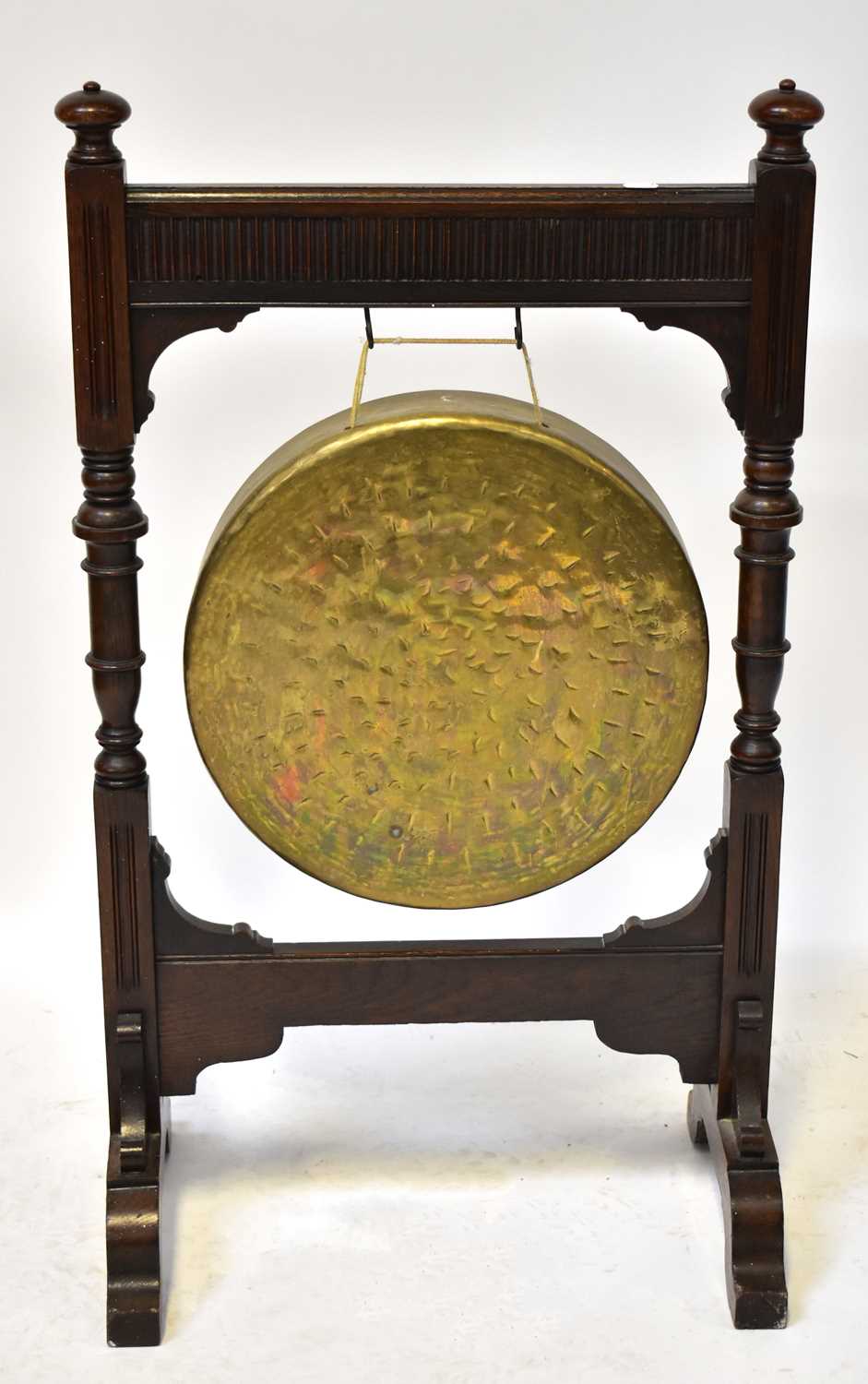 An early 20th century oak dinner gong, with egg and dart decoration to the frieze, height 96cm,