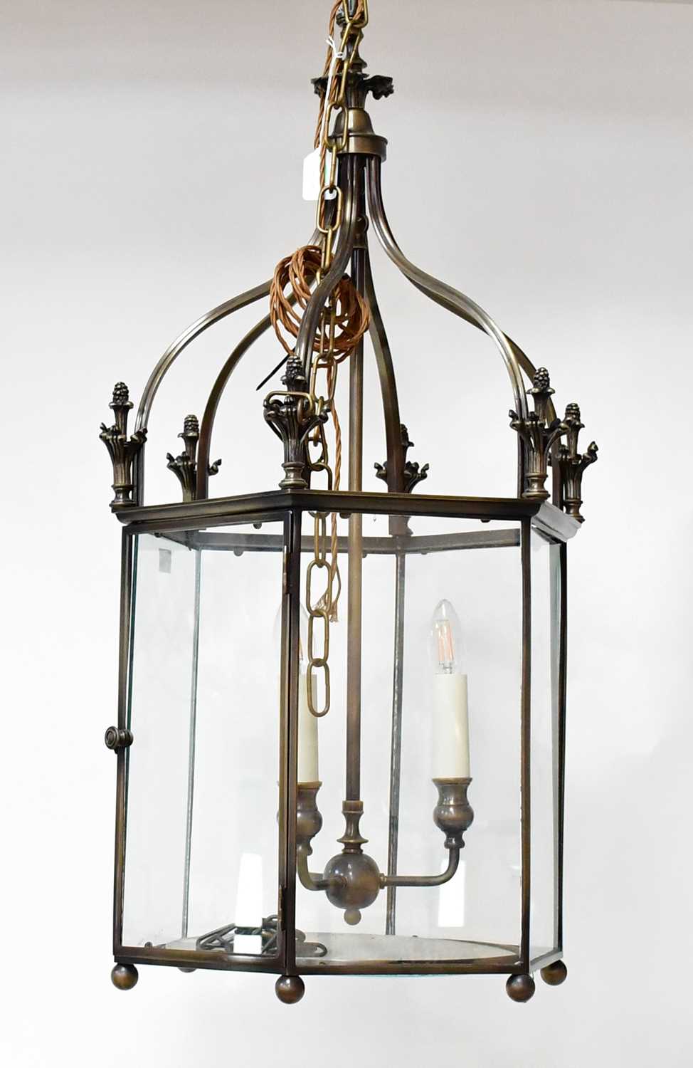 A contemporary bronzed hexagonal hall lantern with three candle-effect fittings, height approx.