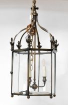 A contemporary bronzed hexagonal hall lantern with three candle-effect fittings, height approx.