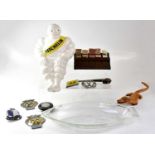 A collection of automobilia and other collectible items, including a plastic Michelin Bibendum,