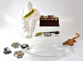 A collection of automobilia and other collectible items, including a plastic Michelin Bibendum,