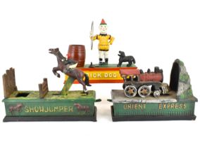 Three replica cast iron money banks comprising 'Trick Dog', 18 x 20.5cm, 'Orient Express', 15 x