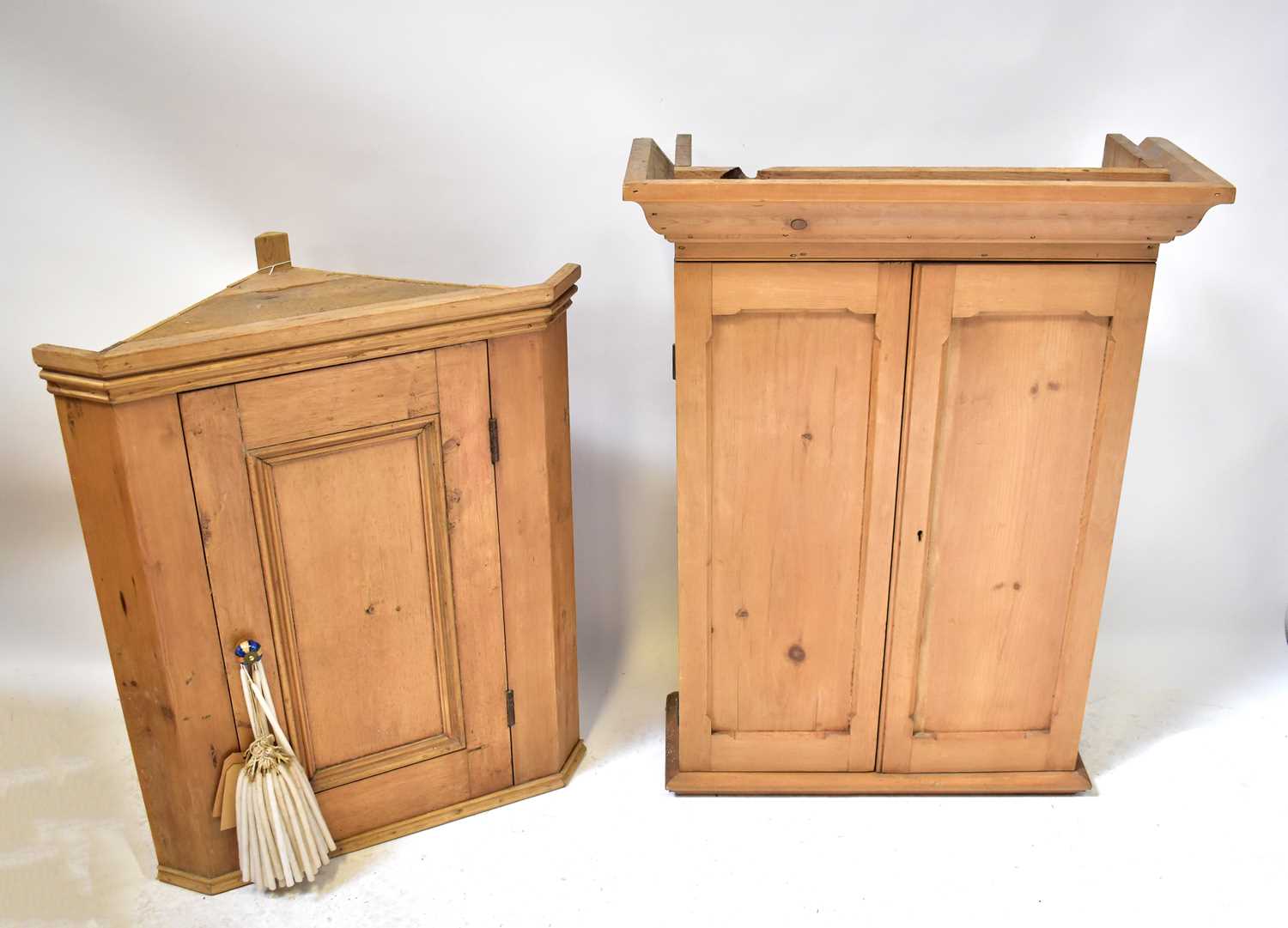 A pine corner wall-hanging cupboard with fielded and panelled door, 86 x 72 x 42cm, together with