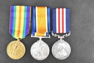 A three medal group comprising Military Medal for bravery in the field, War Medal and Victory Medal,