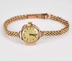 A ladies' 9ct gold wristwatch, the gold-coloured dial set with Arabic numerals, crown wind movement,