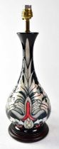 MOORCROFT; a lamp in the 'Snakeshead' design, on a circular wooden base, height including fitment