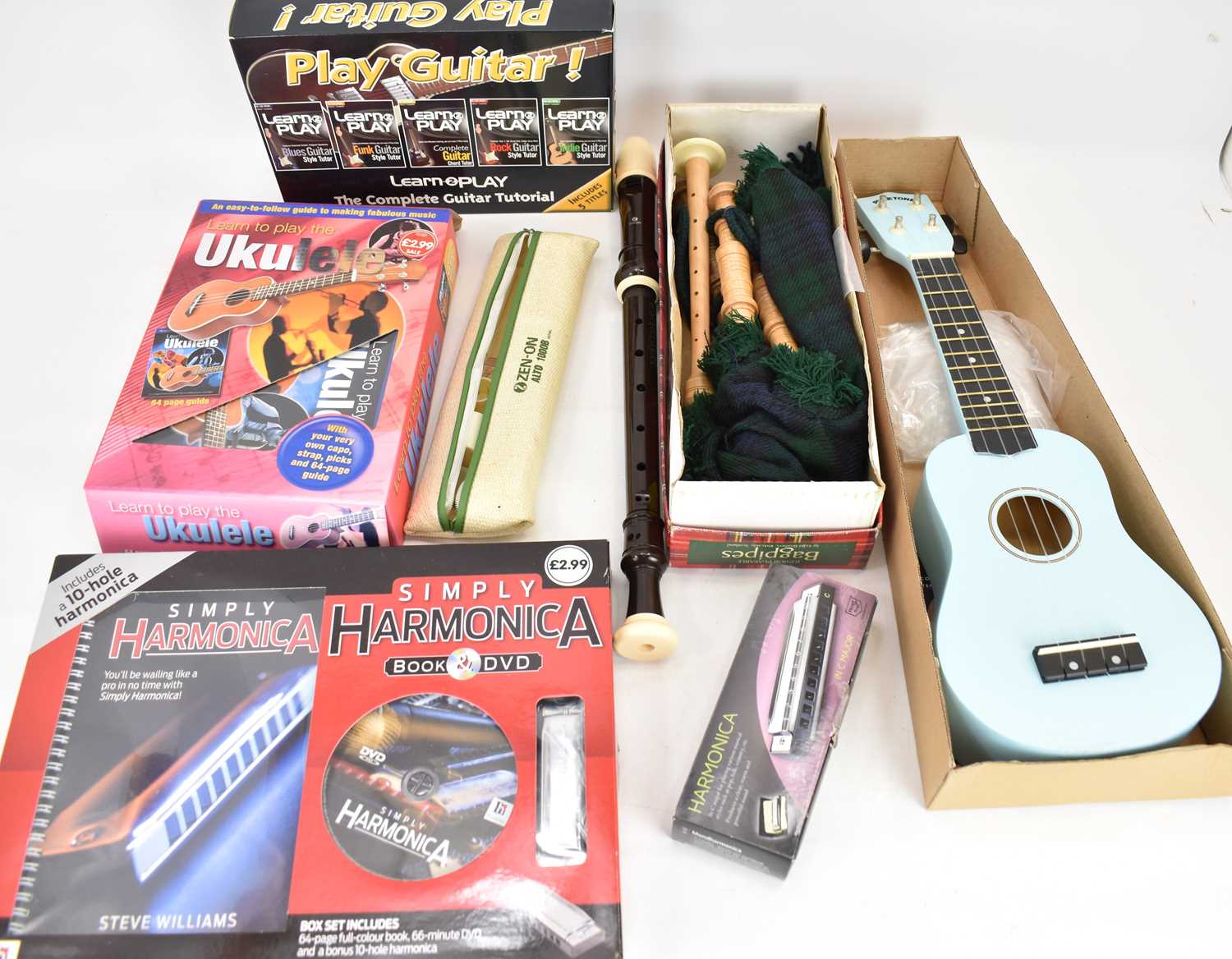 A mixed lot of mainly beginner's musical instruments, etc, comprising boxed junior bagpipes, a boxed