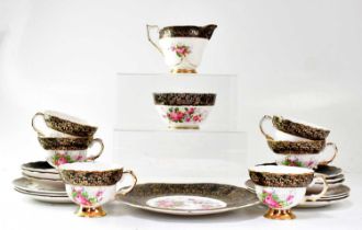 A porcelain part tea service printed with pink roses in a black and gilt-heightened border,