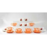 A Fire-King peach lustre tea set and a Pyrex 'June Rose' pattern set of teacups and saucers.