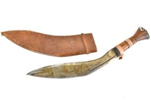 A Kukri with wooden handle and leather scabbard, blade marked 'Tempered Steel, Made in India',