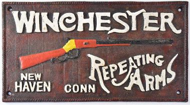 WINCHESTER REPEATING ARMS; a cast iron wall-hanging advertising plaque, stamped verso 'NY1921', with