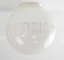 An opaque white glass globe shade etched with the word 'Optician', height 25cm.