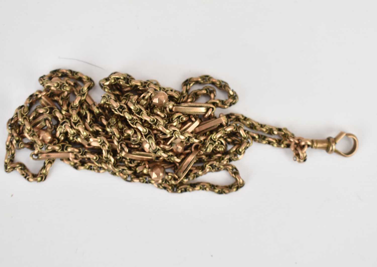 A 9ct rose gold muff chain with swivel clasp and tag which states 9ct, length 140cm, approx. 25.9g. - Image 2 of 2