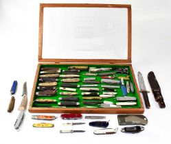 A collection of American Scout knives, Swiss Army knives, pen knives and other knives including a