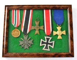 A group of WWII Third Reich medals comprising an Iron Cross, a War Service Cross, Luftwaffe Twenty-