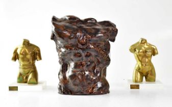 A pair of brass sculptures of a male and female torso by Embryo Sculptures, mounted on Perspex base,