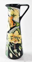 MOORCROFT; a tapered jug decorated with daffodils on a black ground, copyrighted for 2003, limited
