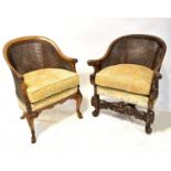 Two double cane walnut armchairs with curved backs terminating in acanthus leaf scroll arms,