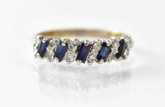 A white metal ring set with baguette cut sapphires interspersed with small diamonds, size T, approx.
