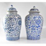 A large 20th century Chinese blue and white ginger jar and cover painted with flowers and scrolls,