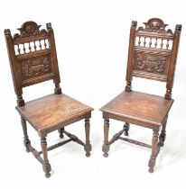 A pair of late 19th/early 20th century oak bobbin turned solid seat dining chairs, the back with