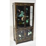 A modern Oriental-style black lacquered gilt-heightened display cabinet, with pair of bevelled glass