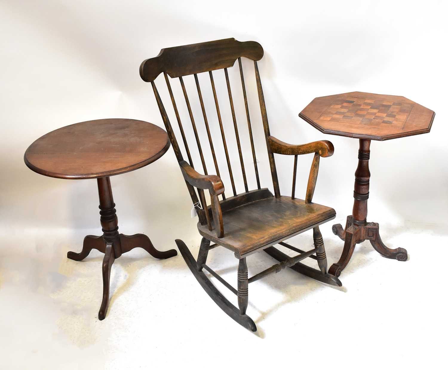 An Edwardian stained wooden rocking chair on turned supports, together with an Edwardian mahogany