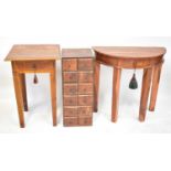 A collection of teak and hardwood furniture comprising a demi-lune table, a square-topped side