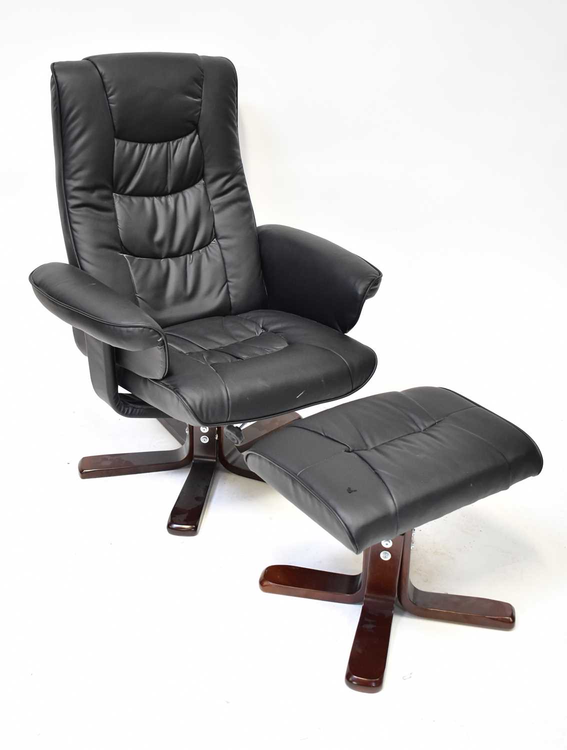 A black faux leather reclining lounge chair and matching footstool (2).