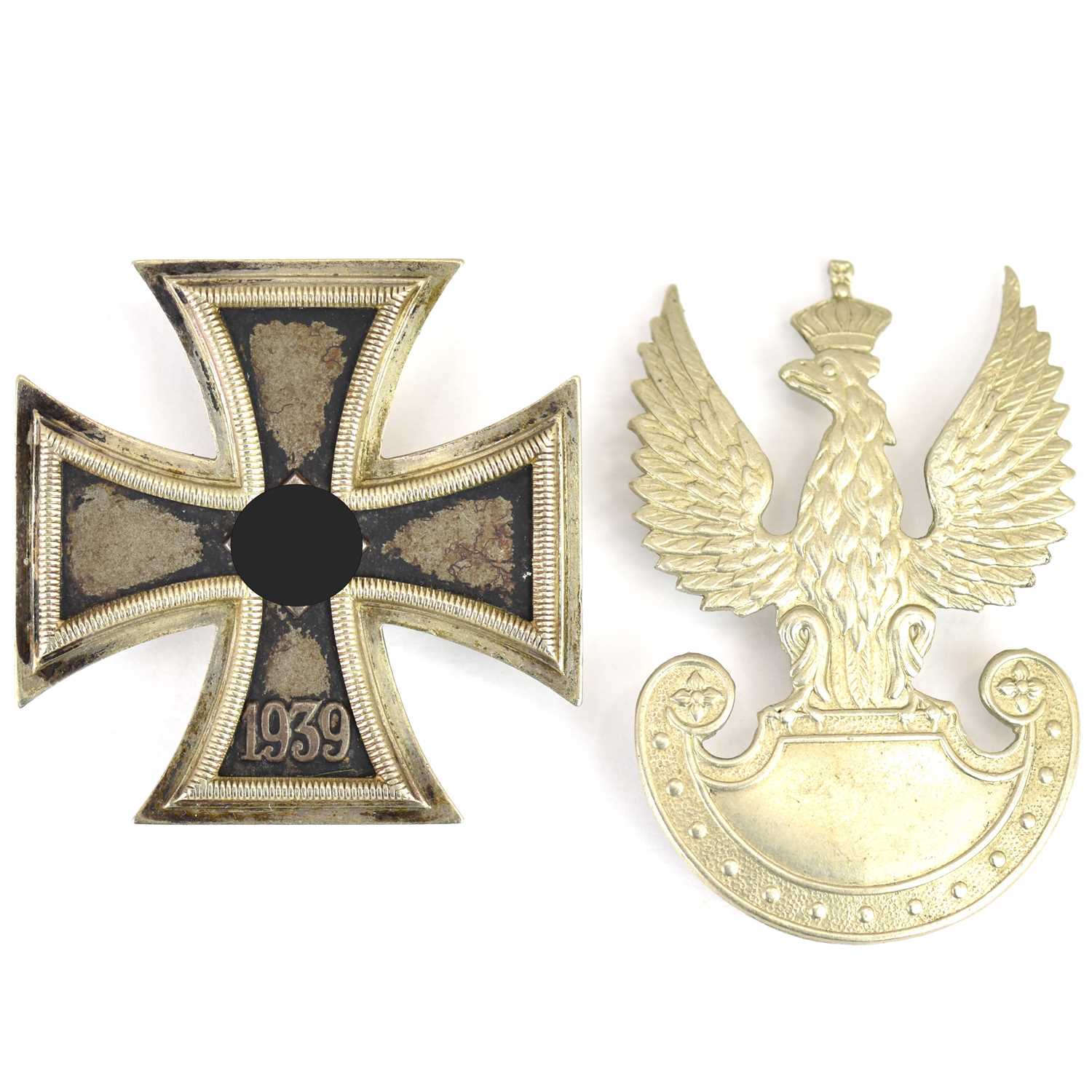 A German WWII First Class Iron Cross, no. 65 to the pin and a Polish cap badge (2).
