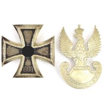 A German WWII First Class Iron Cross, no. 65 to the pin and a Polish cap badge (2).