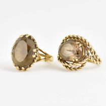 Two 9ct gold dress rings, both claw set with oval smoky quartz, one with rope twist mount, Size K