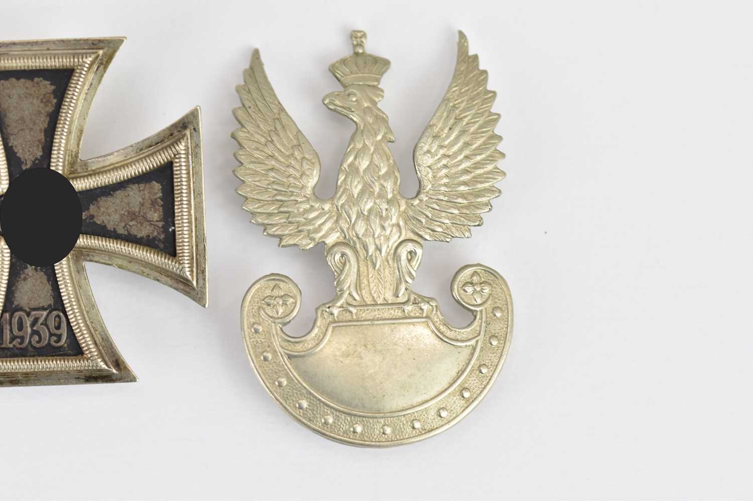 A German WWII First Class Iron Cross, no. 65 to the pin and a Polish cap badge (2). - Image 2 of 2