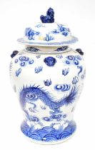 A large 20th century Chinese blue and white ginger jar and cover painted with dragon amongst clouds,
