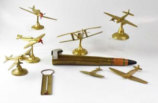 A brass model of a Spitfire on stand to spreading circular foot, height 16cm, a further model