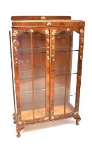 A vintage mahogany two-door display cabinet with three glass inner shelves, glazed sides and