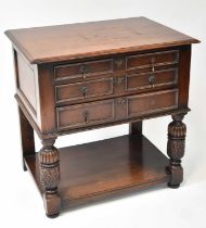 A Victorian oak three-drawer side table with moulded top above three graduated drawers, raised on