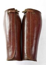 A pair of WWI officer's leather calf gaiters, indistinctly marked. Condition Report: Overall good