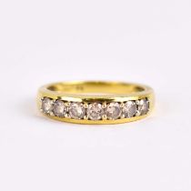 An 18ct yellow gold half eternity ring set with seven small brilliant cut diamonds, combined approx.