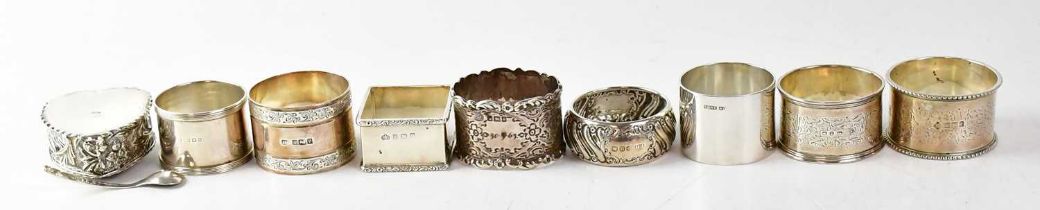 Seven assorted hallmarked napkin rings, including a square example inscribed 'Margaret' and