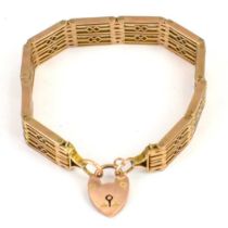 An Edwardian-style 9ct gold hinged gate bracelet of ten panels, with 9ct gold heart-shaped padlock