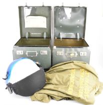 A military pilot's helmet, a pair of gloves, a canvas bag, a green jumpsuit with yellow