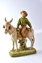 ROYAL DUX; a figure of a boy riding a donkey, with impressed Royal Dux triangle, impressed number '