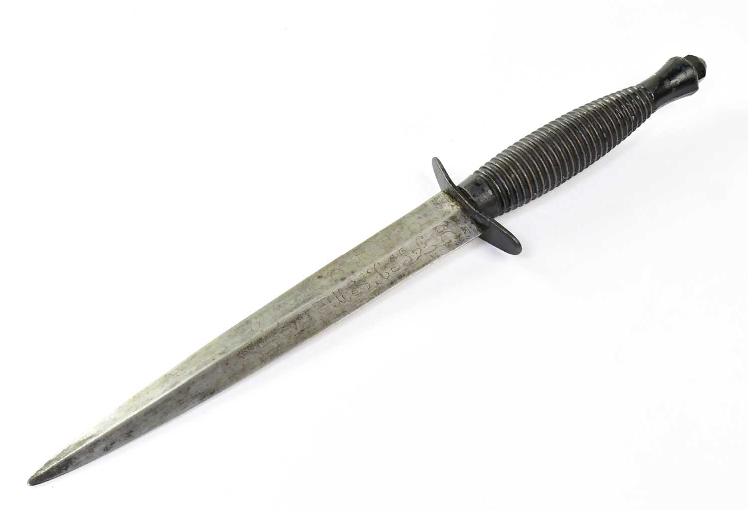 A Sykes Fairbairn third pattern commando dagger with, 7" double-edged blade, ribbed grip, embossed