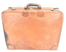 A vintage Hartmann Belting leather suitcase with internal suit compartments and covers, brass