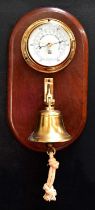 A Sewills Liverpool barometer brass porthole cased and mounted on a wooden board with bell below,