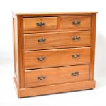 An Edwardian-style waxed pine chest of two short over three long graduated drawers on a plinth base,