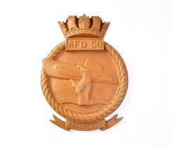 A cast alloy wall plaque inscribed 'AFD 58' depicting a hand holding a submarine with scrolling