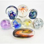 Eight art glass paperweights comprising three with cased fish, tallest 9cm, two with flower heads