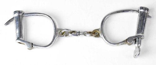 A pair of vintage chrome plated handcuffs stamped 'Hiatt' and further stamped 'British Made', with